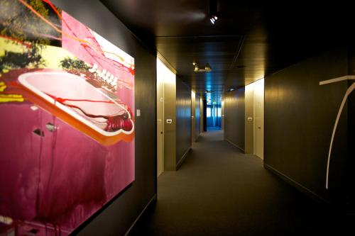 a hallway with a large painting on the wall at Mercure Nerocubo Rovereto in Rovereto