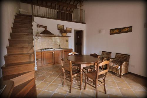 a kitchen and dining room with a table and stairs at Rustico del Conero in Camerano