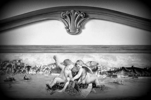 a painting of two men in a painting in a frame at Rustico del Conero in Camerano