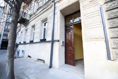 a door on the side of a building with a tree at Jardin Vera in Tbilisi City