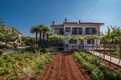 a house with a garden in front of it at Apartman Ana in Krk