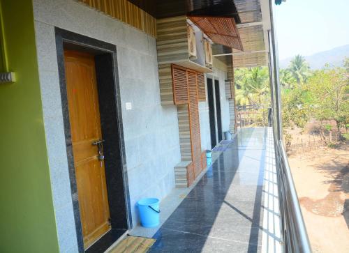 an open door of a building with a porch at Shreyas Guest house - Tatkare Villa in Kashid