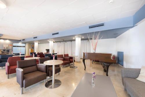 a lobby with a piano and chairs and a waiting room at Be Live Experience Costa Palma in Palma de Mallorca