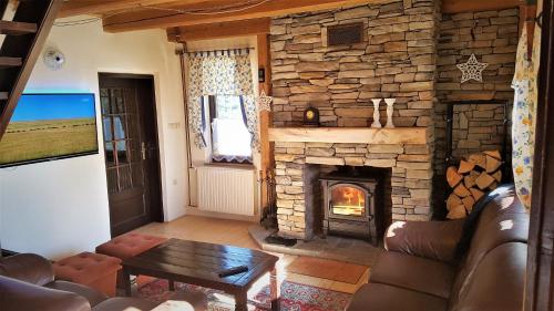 a living room with a large stone fireplace at Rogla - Chalet Mojca Pokrajculja in Zreče