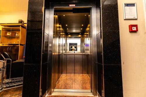 an elevator corridor in a building with a person walking down it at Akzent Hotel Tietmeyer & Cross Side in Schöppingen