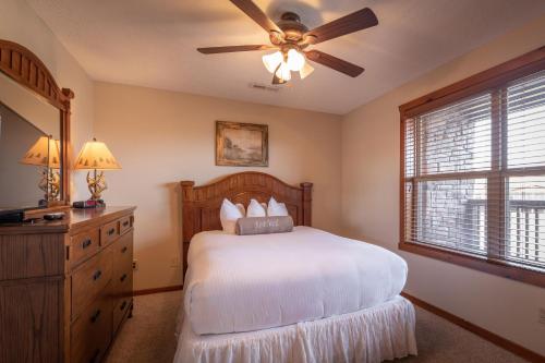 a bedroom with a bed and a ceiling fan at The Lodges at Table Rock in Branson