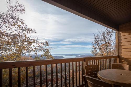 a view from the deck of a cabin with a table and chairs at The Lodges at Table Rock in Branson