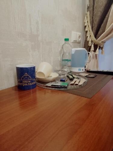 a table with a coffee maker and a bottle of water at Centralnyi hotel in Poltava