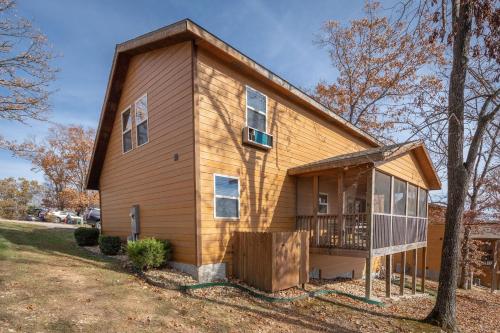 a house with a gambrel roof and a porch at The Lodges at Table Rock in Branson