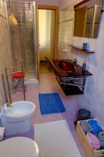 a bathroom with a sink and a toilet and a shower at Villa Ella in Rome