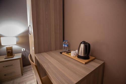 a room with a table with a microwave on it at Staron Otel in Zonguldak