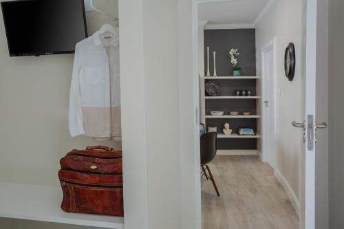 a hallway with a room with a suitcase at Tehillah Guest House in George