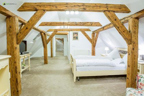 a bedroom with two beds in a room with wooden beams at Palatul Brukenthal Avrig in Avrig