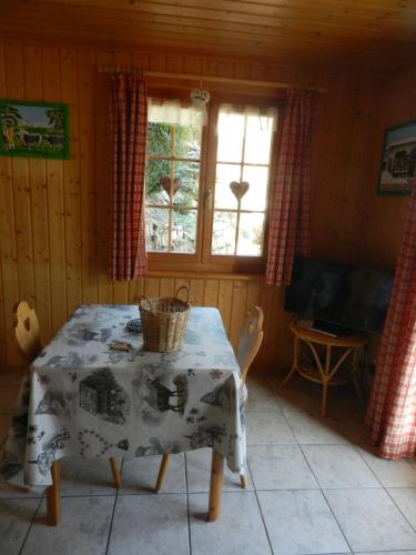 a dining room with a table with a basket on it at Waldruhe in Jaun