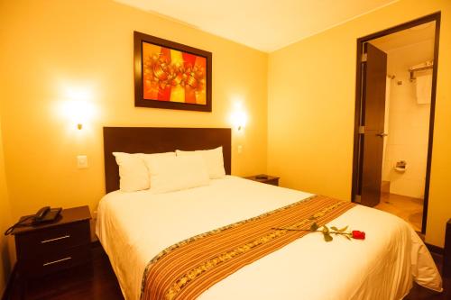 a bedroom with a large bed with areath on it at Casa Suyay in Lima