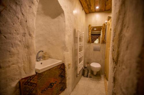a small bathroom with a sink and a toilet at Zen Cappadocia in Uçhisar