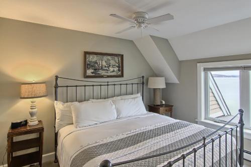 a bedroom with a bed and a ceiling fan at 312 Water Street Inn in Boyne City