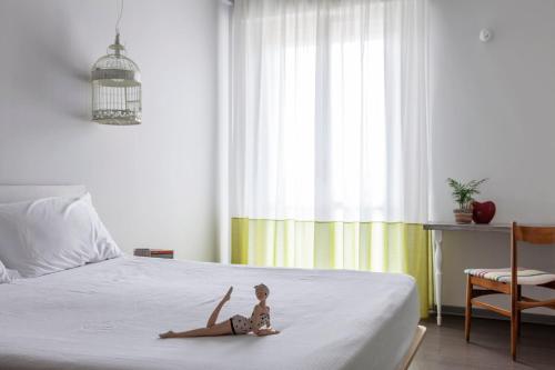 a doll laying on a bed in a bedroom at Hotel Madison in Rimini
