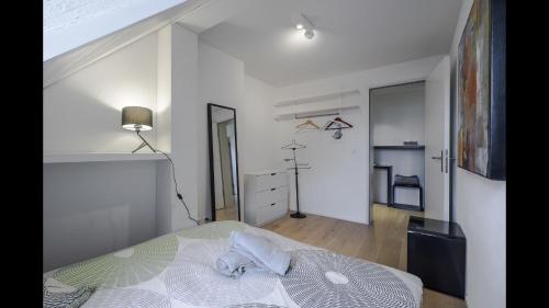 a white bedroom with a bed in a room at Luxury Penthouse Apartment in Zürich