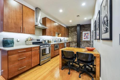 a kitchen with wooden cabinets and a wooden table at Loft in Lower Nob Hill in San Francisco