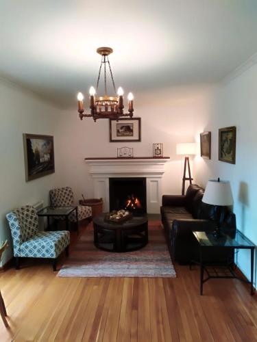 a living room with a couch and a fireplace at Hostería Pionero in Cerro Castillo