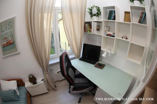 an office with a desk with a laptop on it at Apartments Morski Svet Portorož in Portorož