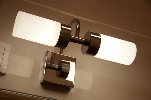 a pair of lights hanging on a wall at Green Island in the downtown with free parking in Debrecen