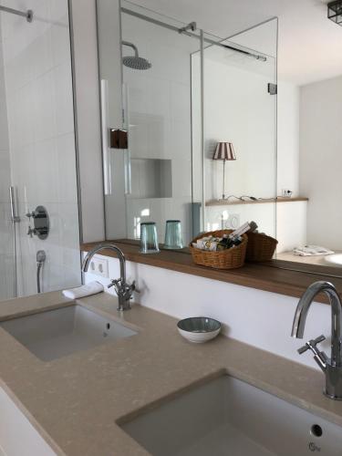 a bathroom with a sink and a mirror at Hof Kaltenbrunn in Aying