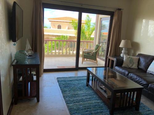 a living room with a couch and a coffee table at The Meridian at Lighthouse Point in West Bay