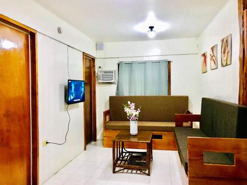 a living room with a couch and a table at Lanzones Cabana in Mambajao