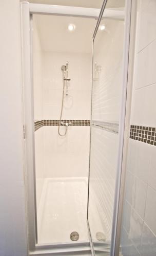 a shower with a glass door in a bathroom at The Hedley Townhouse in Bournemouth