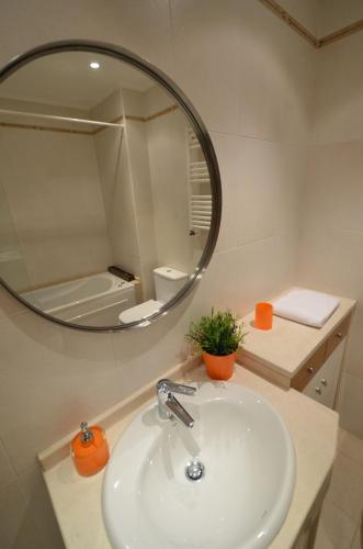 a bathroom with a sink and a mirror at Expo Marina Lis in Lisbon