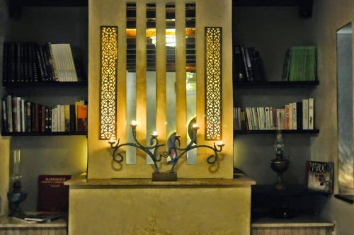 a candle holder on a table in a room with books at Riad L'Evidence in Marrakech