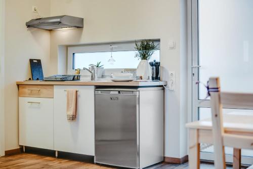 a kitchen with a sink and a counter top at Bestes apartamenti in Kocēni