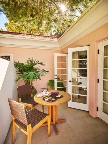 a patio with a table and chairs on a patio at Hotel Bel-Air - Dorchester Collection in Los Angeles