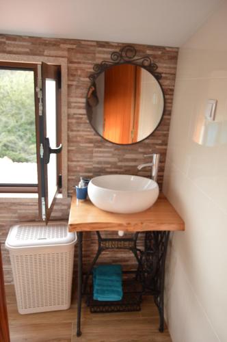 a bathroom with a sink and a mirror at Casa do Ribeiro in Sever do Vouga