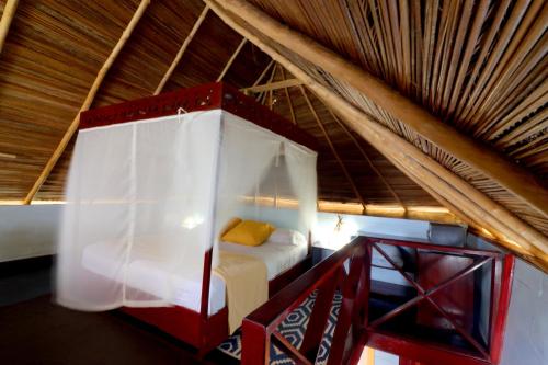 a bedroom with a bed in a roof at Punta Caracol Acqua Lodge in Bocas del Toro