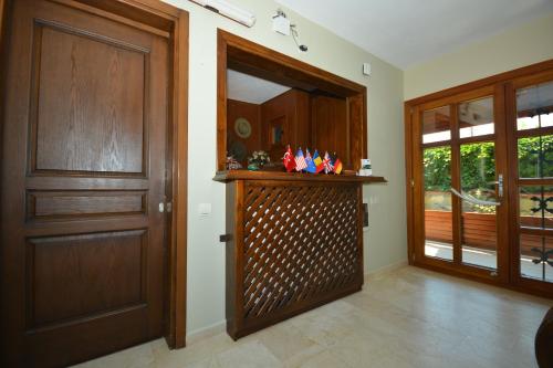 a hallway with a wooden door and a mirror at Hotel Casa Villa in Eceabat