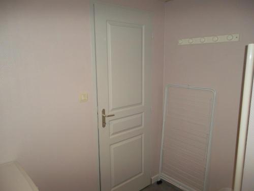 a white door in a room with a closet at Appartement au centre du tholy pour 5 personnes maximum in Le Tholy