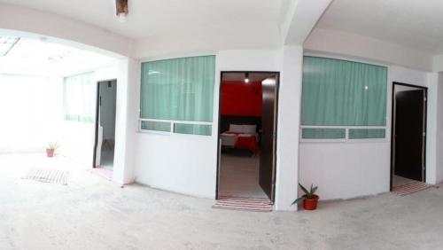 a room with green and white walls and a bed at Hotel Boutique Otomi cerca de Tolantongo in Cardonal