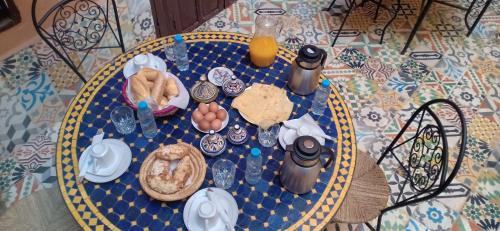 a table topped with plates of food and drinks at Riad Jbara in Rabat
