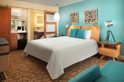 a bedroom with a large white bed and a desk at Movie Colony Hotel - Adults Only in Palm Springs