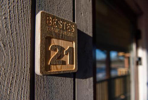 a sign on the side of a building with the number at Bestes apartamenti in Kocēni