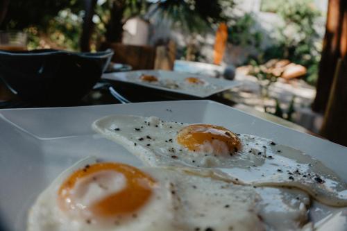 two fried eggs on a plate on a table at Samara Chillout Lodge - Adults only in Sámara