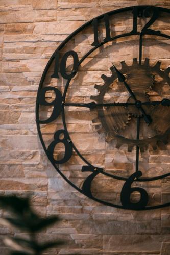 a clock on the side of a brick wall at The Lighthouse in Trappeto