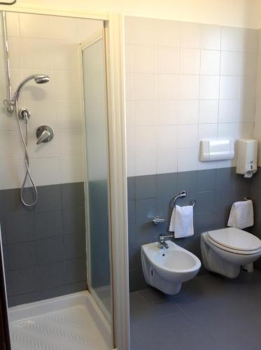 a bathroom with a shower and a toilet and a sink at Ospitalità San Tommaso d'Aquino in Bologna