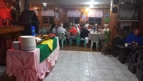 a group of people sitting at tables in a restaurant at Las vegas lodge and restaurant in Banaue
