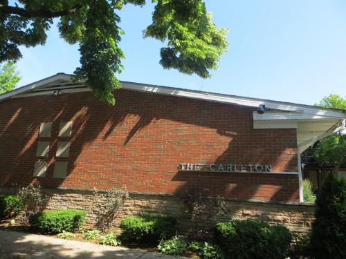 a brick building with a sign that reads the coalition at Carleton of Oak Park in Oak Park