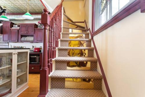 a spiral staircase in a kitchen with purple cabinets at Rose Street Bed & Breakfast in Georgetown