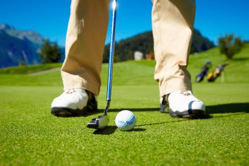 a man is playing golf with a golf ball at Walch's Camping & Landhaus in Braz